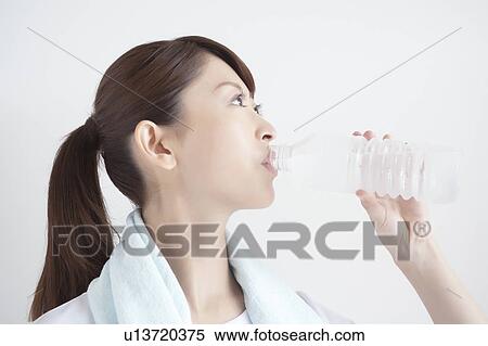 Stock Photography - Young Woman Cooling Down and Drinking Water. Fotosearch