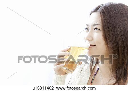 Young woman drinking a glass of beer, Tokyo Prefecture, Honshu, Japan View Large Photo Image Stock Image - Young woman drinking a glass of beer, Tokyo Prefecture, Honshu, Japan. Fotosearch