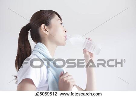 Stock Image - Young Woman Drinking Water. Fotosearch