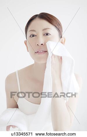 Stock Image - Young Woman Drying Face. Fotosearch