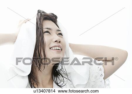 Picture - Young woman drying her hair with towel, Tokyo Prefecture, Honshu, Japan. Fotosearch