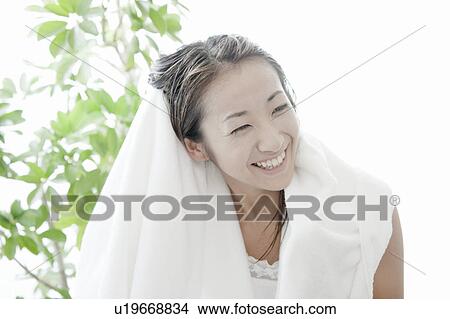 Picture - Young woman drying her hair with towel, Tokyo Prefecture, Japan. Fotosearch