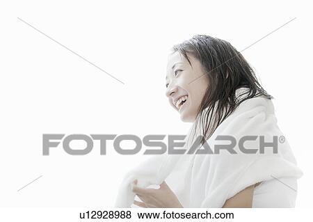 Stock Photo - Young woman drying her hair with towel, Tokyo Prefecture, Japan. Fotosearch