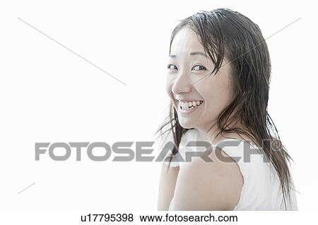 Stock Photo - Young woman drying her hair with towel, Tokyo Prefecture, Japan. Fotosearch