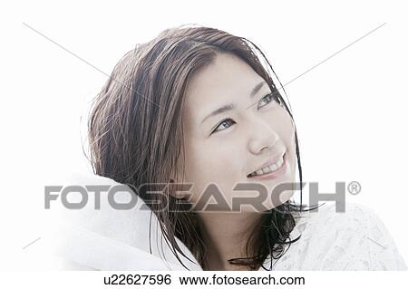Stock Photograph - Young woman drying her hair with towel, Tokyo Prefecture, Honshu, Japan. Fotosearch