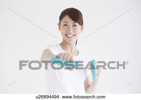 Young Woman Exercising with Dumbbells View Large Photo Image Picture - Young Woman Exercising with Dumbbells. Fotosearch