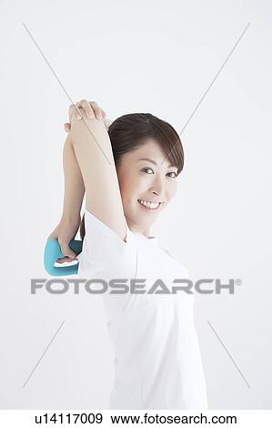 Young Woman Exercising with Dumbbells View Large Photo Image Stock Photo - Young Woman Exercising with Dumbbells. Fotosearch