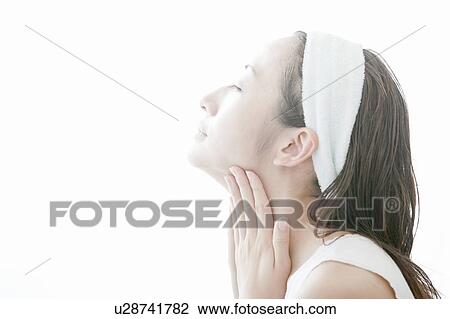 Young woman giving herself a facial massage, Tokyo Prefecture, Japan View Large Photo Image Stock Image - Young woman giving herself a facial massage, Tokyo Prefecture, Japan. Fotosearch