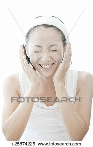 Young woman giving herself a facial massage, Tokyo Prefecture, Japan View Large Photo Image Stock Photography - Young woman giving herself a facial massage, Tokyo Prefecture, Japan. Fotosearch
