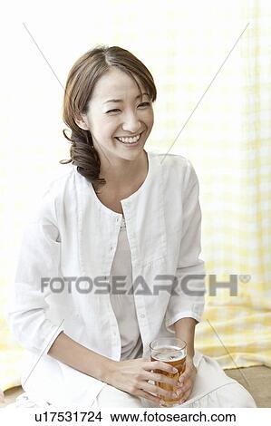 Young woman holding a glass of beer, Tokyo Prefecture, Japan View Large Photo Image Picture - Young woman holding a glass of beer, Tokyo Prefecture, Japan. Fotosearch