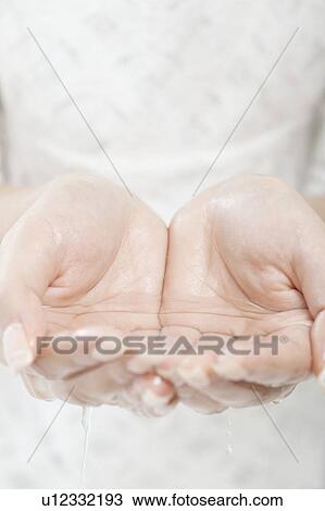 Young woman holding water in her hands, Tokyo Prefecture, Honshu, Japan View Large Photo Image Stock Image - Young woman holding water in her hands, Tokyo Prefecture, Honshu, Japan. Fotosearch