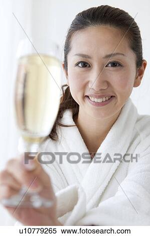 Stock Photography - Young Woman in Dressing Gown Having Champagne. Fotosearch