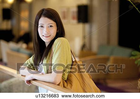Young Woman Leaning Against Railing View Large Photo Image Stock Image - Young Woman Leaning Against Railing. Fotosearch