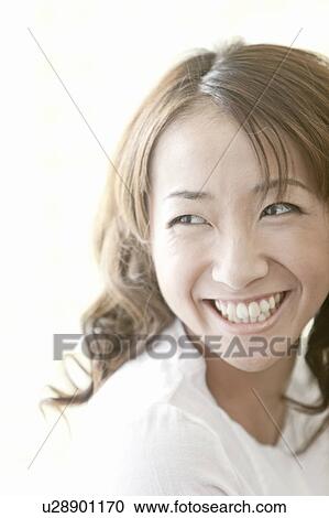 Young woman looking away and smiling, Tokyo Prefecture, Japan View Large Photo Image Stock Image - Young woman looking away and smiling, Tokyo Prefecture, Japan. Fotosearch