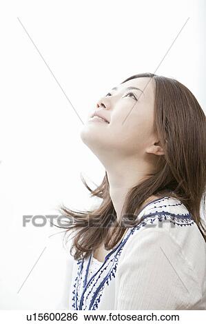 Young woman looking up, Tokyo Prefecture, Honshu, Japan View Large Photo Image Stock Photograph - Young woman looking up, Tokyo Prefecture, Honshu, Japan. Fotosearch
