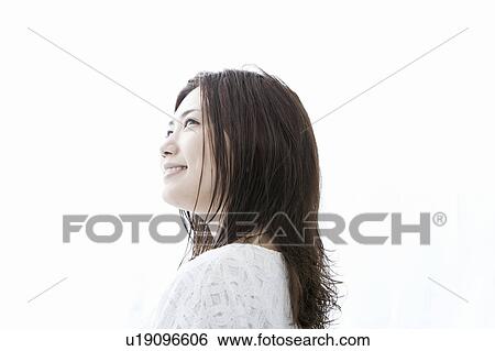Stock Photograph - Young woman looking up, Tokyo Prefecture, Honshu, Japan. Fotosearch