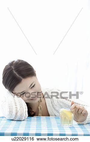 Young woman mixing drink with finger, Tokyo Prefecture, Honshu, Japan View Large Photo Image Stock Photograph - Young woman mixing drink with finger, Tokyo Prefecture, Honshu, Japan. Fotosearch