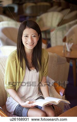Young Woman Reading Book in Lobby View Large Photo Image Stock Image - Young Woman Reading Book in Lobby. Fotosearch