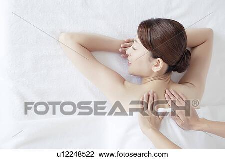 Stock Image - Young Woman Receiving Massaging. Fotosearch
