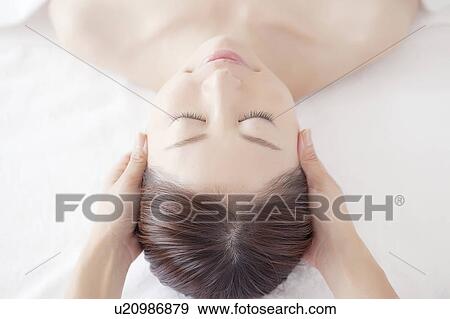 Stock Photo - Young Woman Receiving Massaging. Fotosearch