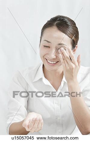 Young woman removing make-up, Tokyo Prefecture, Japan View Large Photo Image Stock Photography - Young woman removing make-up, Tokyo Prefecture, Japan. Fotosearch