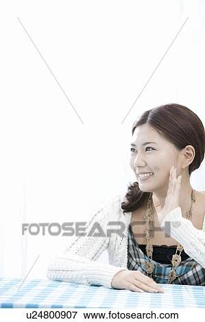 Young woman sitting at table waving, Tokyo Prefecture, Honshu, Japan View Large Photo Image Stock Photo - Young woman sitting at table waving, Tokyo Prefecture, Honshu, Japan. Fotosearch