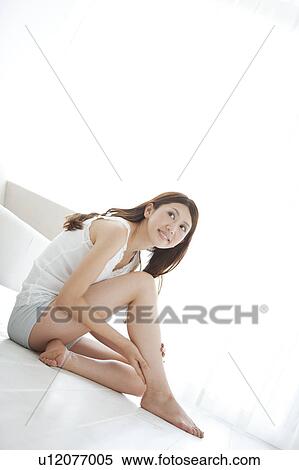 Young Woman Sitting on Floor and Touching Her Leg View Large Photo Image Stock Photography - Young Woman Sitting on Floor and Touching Her Leg. Fotosearch