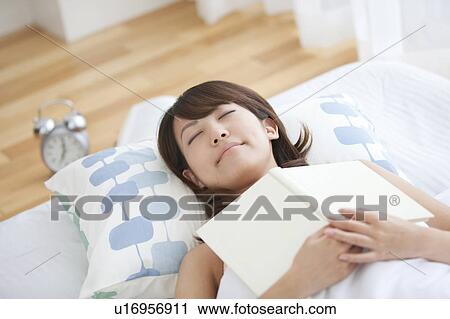 Young Woman Sleeping with Book on Chest View Large Photo Image Stock Image - Young Woman Sleeping with Book on Chest. Fotosearch