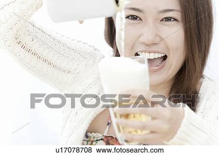 Young woman smiling and pouring beer, Tokyo Prefecture, Honshu, Japan View Large Photo Image Stock Photo - Young woman smiling and pouring beer, Tokyo Prefecture, Honshu, Japan. Fotosearch