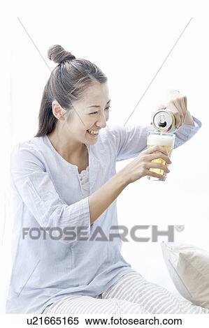 Young woman smiling and pouring beer, Tokyo Prefecture, Japan View Large Photo Image Stock Photography - Young woman smiling and pouring beer, Tokyo Prefecture, Japan. Fotosearch