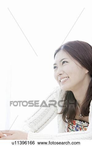 Stock Photograph - Young woman smiling, Tokyo Prefecture, Honshu, Japan. Fotosearch