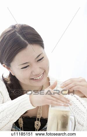 Young woman squeezing lemon into highball, Tokyo Prefecture, Honshu, Japan View Large Photo Image Stock Image - Young woman squeezing lemon into highball, Tokyo Prefecture, Honshu, Japan. Fotosearch