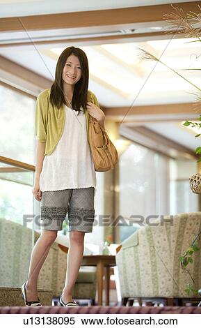 Young Woman Standing in Lobby View Large Photo Image Stock Photography - Young Woman Standing in Lobby. Fotosearch