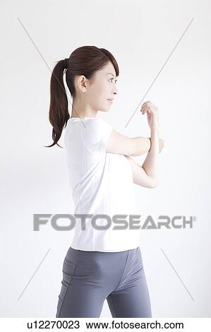 Stock Image - Young Woman Stretching. Fotosearch