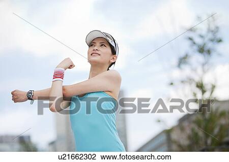 Stock Image - Young Woman Stretching. Fotosearch
