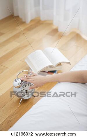 Young Woman Switching Off Alarm Clock View Large Photo Image Stock Image - Young Woman Switching Off Alarm Clock. Fotosearch