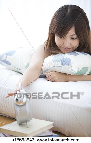Young Woman Switching Off Alarm Clock View Large Photo Image Stock Image - Young Woman Switching Off Alarm Clock. Fotosearch
