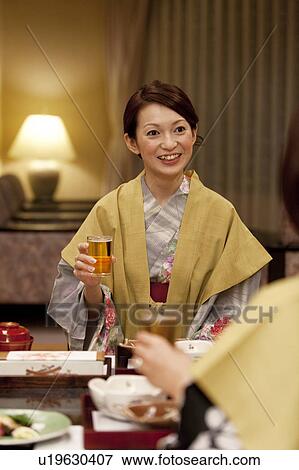 Young Woman Talking at Dinner Table View Large Photo Image Stock Photo - Young Woman Talking at Dinner Table. Fotosearch
