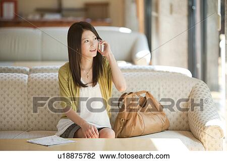 Young Woman Talking on Phone in Lobby View Large Photo Image Stock Image - Young Woman Talking on Phone in Lobby. Fotosearch