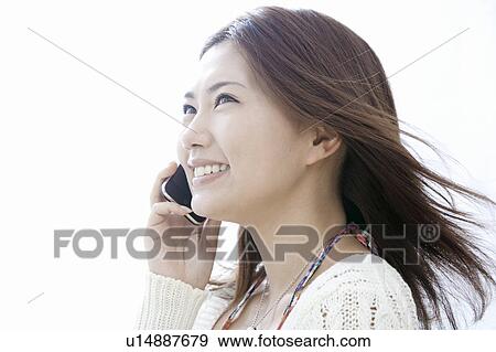 Young woman talking on smart phone, Tokyo Prefecture, Honshu, Japan View Large Photo Image Stock Photo - Young woman talking on smart phone, Tokyo Prefecture, Honshu, Japan. Fotosearch