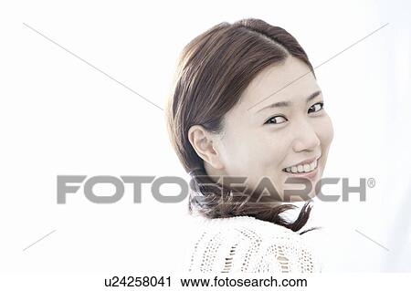 Young woman turning and looking at camera, Tokyo Prefecture, Honshu, Japan View Large Photo Image Stock Image - Young woman turning and looking at camera, Tokyo Prefecture, Honshu, Japan. Fotosearch