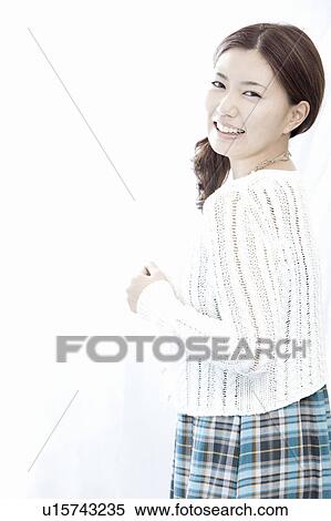 Young woman turning and looking at camera, Tokyo Prefecture, Honshu, Japan View Large Photo Image Stock Photography - Young woman turning and looking at camera, Tokyo Prefecture, Honshu, Japan. Fotosearch