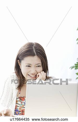 Young woman using a laptop, Tokyo Prefecture, Honshu, Japan View Large Photo Image Stock Photography - Young woman using a laptop, Tokyo Prefecture, Honshu, Japan. Fotosearch