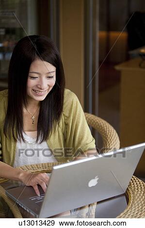 Stock Photo - Young Woman Using Laptop. Fotosearch