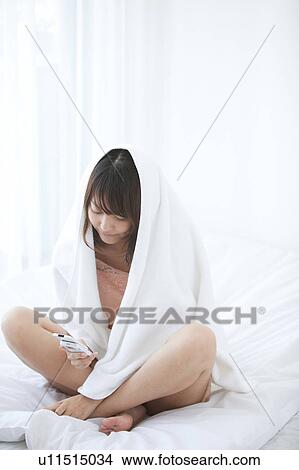 Young Woman Using Mobile Phone in Bed View Large Photo Image Picture - Young Woman Using Mobile Phone in Bed. Fotosearch