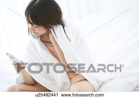 Young Woman Using Mobile Phone in Bed View Large Photo Image Stock Image - Young Woman Using Mobile Phone in Bed. Fotosearch