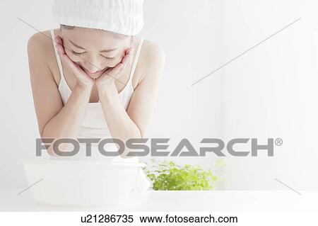 Stock Photography - Young Woman Washing Face. Fotosearch