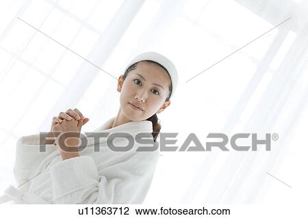 Stock Image - Young Woman Wearing Bathrobe. Fotosearch