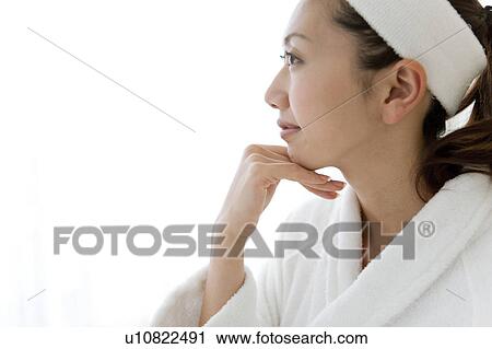 Stock Image - Young Woman Wearing Hairband and Dressing Gown. Fotosearch