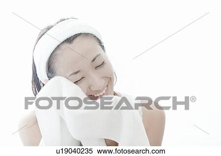 Young woman wiping her face with a towel, Tokyo Prefecture, Japan View Large Photo Image Stock Photography - Young woman wiping her face with a towel, Tokyo Prefecture, Japan. Fotosearch